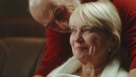 elderly couple enjoying affectionate moment at home