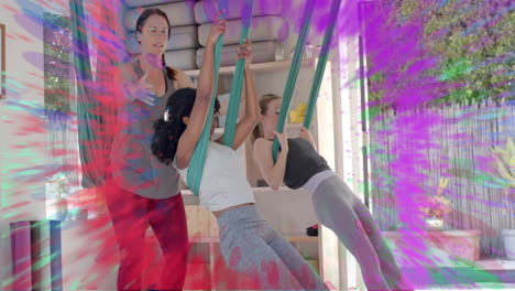 animation of colourful trails over diverse female instructor and teenage girls doing aerial yoga