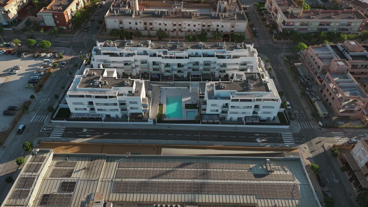 Aerial reverse shot over Malaga hotel and apartment buildings