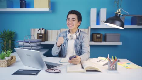 young man screaming for joy at what he sees on the screen while texting on the phone.