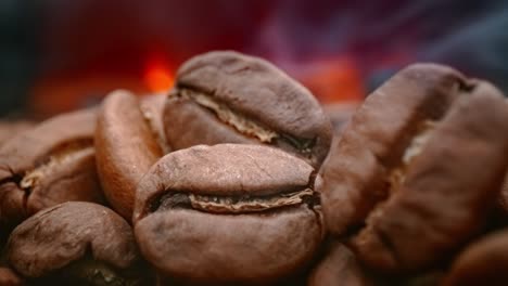 close up of seeds of coffee. fragrant coffee beans are roasted smoke comes from coffee beans.