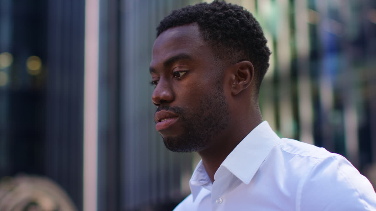 Close Up Of Tired Young Businessman In Shirt Sleeves Rubbing Eyes Standing Outside Offices In The Financial District Of The City Of London UK