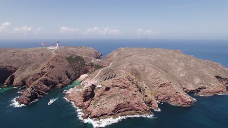 Aerial-view-approaching-Berlenga-Grande-archipelago-island-towards-the-hilltop-lighthouse-landmark