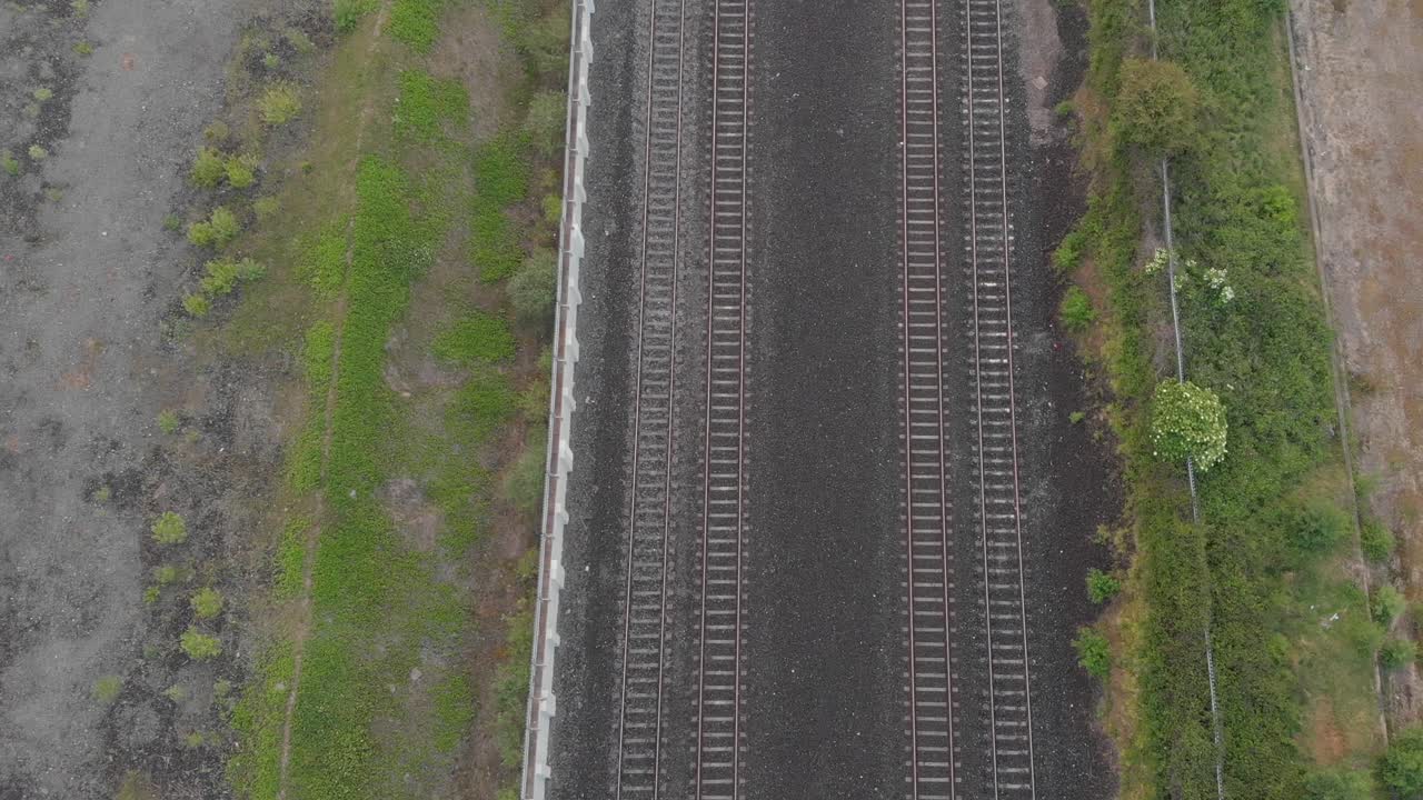 Passenger Train Passing By On The Railway At The Countryside In County Kildare, Ireland - aerial top view
