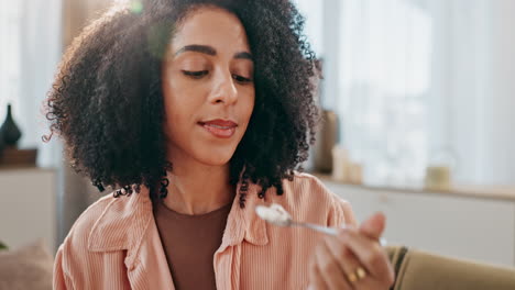 woman with curly hair eating with a spoon