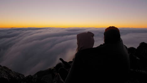 hikers bonding and enjoying the dusk, above clouds on mount hassell, in west australia