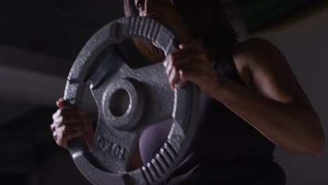 Close-Up-Studio-Shot-Of-Mature-Woman-Wearing-Gym-Fitness-Clothing-Lifting-Weights-For-Cardio-Exercise