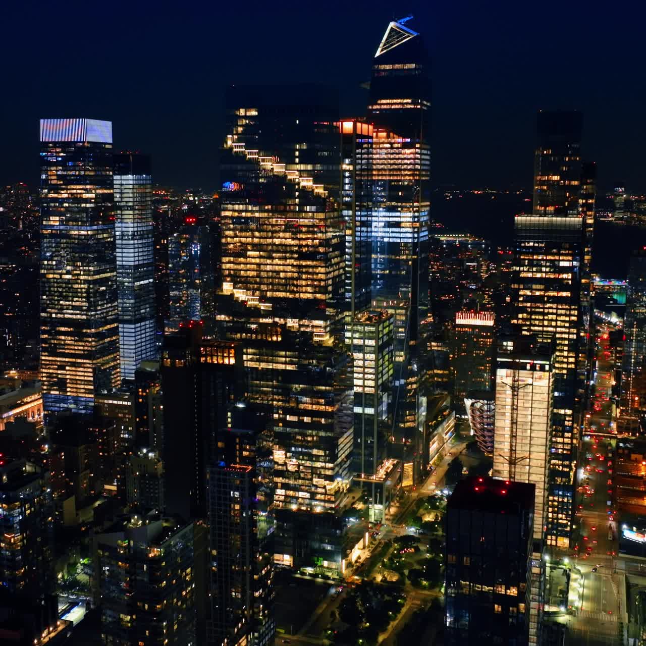 Rising to the tops of magnificent skyscrapers. Amazing New York full of lights at night. Top view panorama