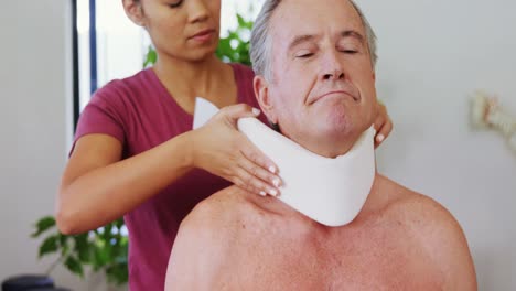 physiotherapist adjusting cervical collar on the patients neck 4k