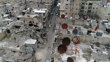 drone view over the streets in aleppo, syria. people live their life between the ruins of the city 4k