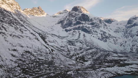 Incredible-aerial-shot-of-snow-covered-mountains-on-Kvaloya,-Norway