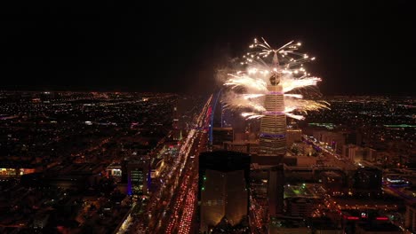 aerial shot of fireworks from al faisaliyah tower and other towers.