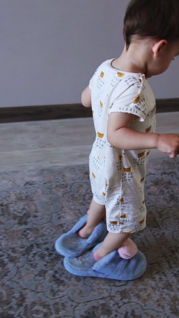 Lovely little kid wearing blue fluffy slippers crosses the room. Kid borrowed his mom's footwear. Vertical video