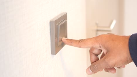 a finger turning on lighting switch