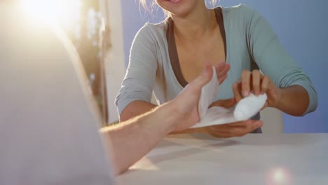 woman taking off hand bandage