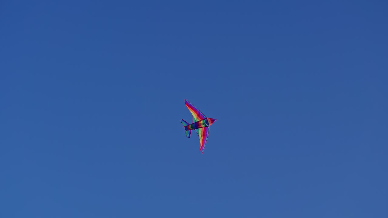 Bright kite flying in sky. Colorful kite flying in the wind against sky