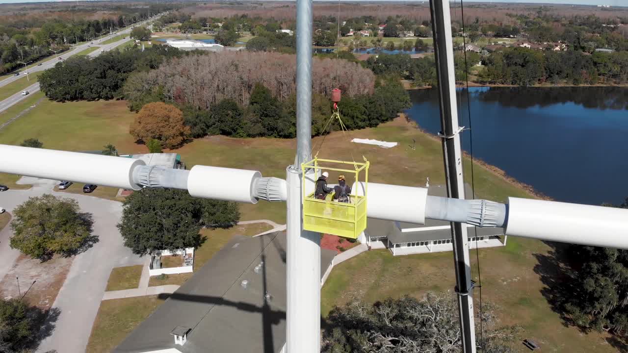 십자가 모양의 드폰 타워를 설치하는 기술자