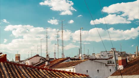 time-lapse antennas on roof sky and clouds