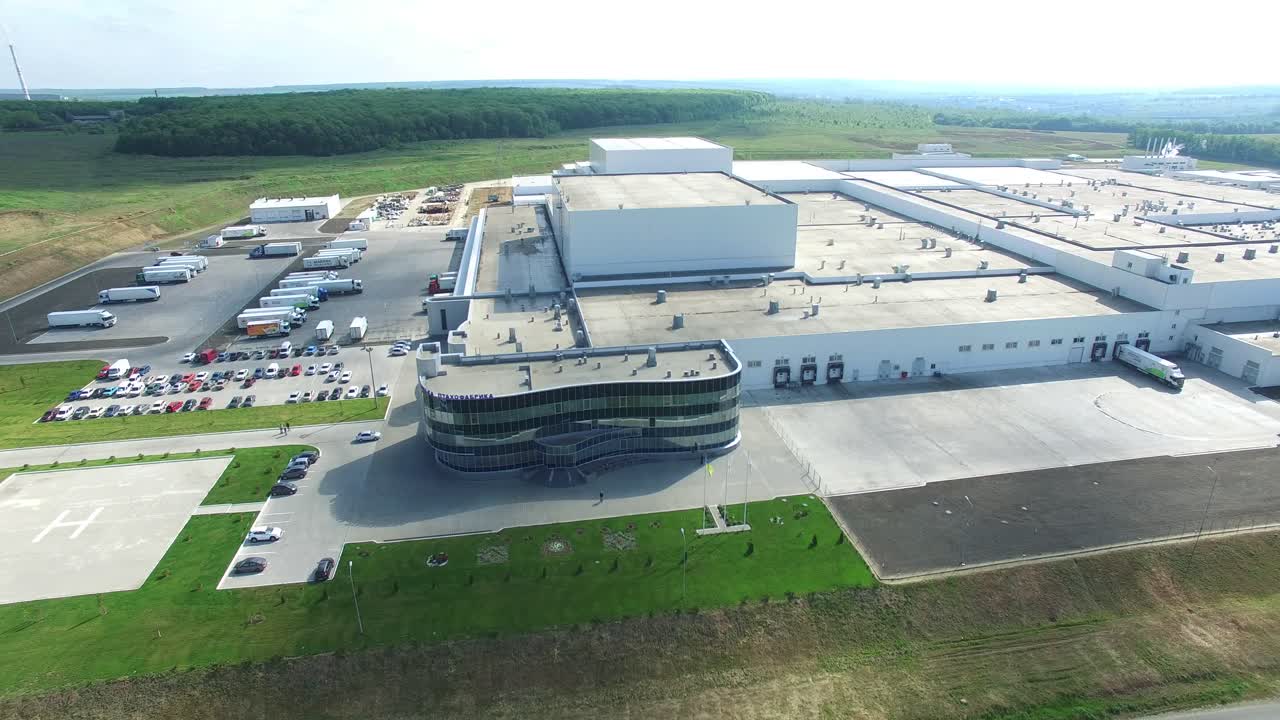 Aerial view of warehouse with trucks. Industrial background. Logistics from above