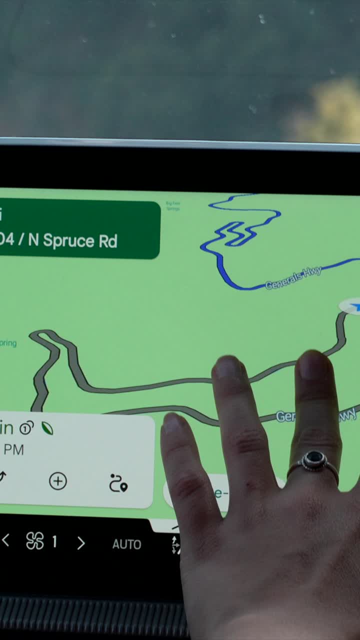 Hand Interacting with Car Navigation Touch Screen Map