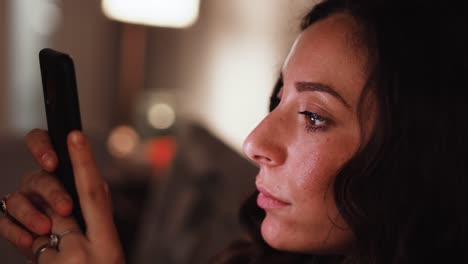 Young-Italian-woman-becomes-shocked-while-looking-at-her-smart-phone