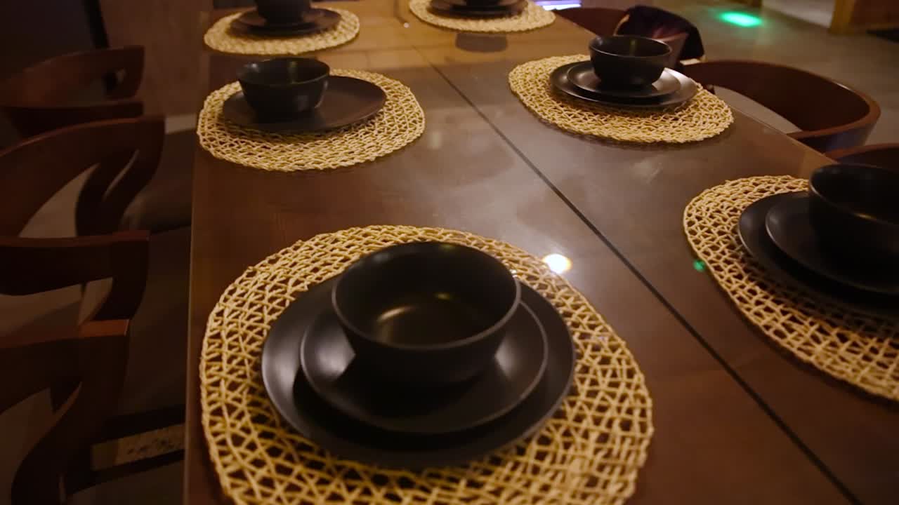 Aerial pan right shot of crockery on table in dining room
