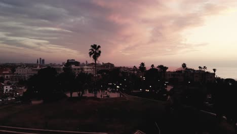 A-drone-flying-through-the-amphetheater-to-the-sunset-at-Jaffo-4K