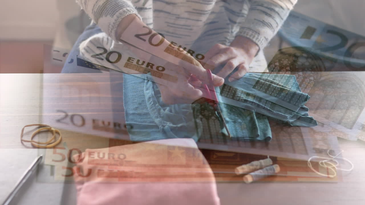 video compuesto digital de billetes de euro que se mueven contra una mujer que cose máscaras de as en el fondo