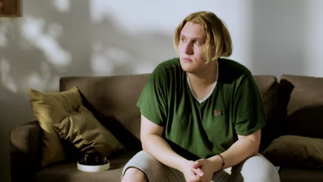 young man looking out of the window and at front in the end