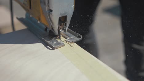 Cutting-mark-plywood-timber-with-powered-jigsaw-Slow-motion-Close-up