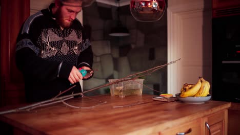 a man trimming small tree branches for the purpose of propagation - static shot