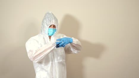 nurse-removing-the-seal-of-the-glove-with-the-protective-suit-ppe