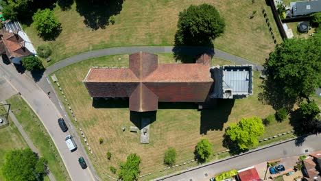 A-top-down-pan-of-St-Mary's-Church-in-Chartham,-showing-its-cross-shape