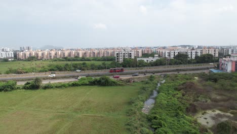 Aerial-Drone-Shot-of-Buildings-surrounded-by-green-farming-area