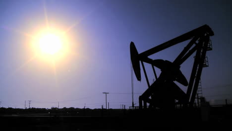 silhouette of oil pumpjacks in operation