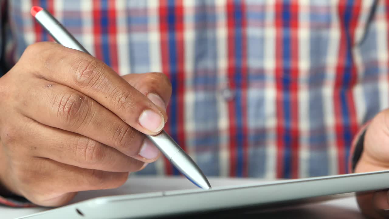 Person using a digital tablet with stylus