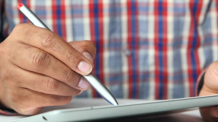 Person using a digital tablet with stylus