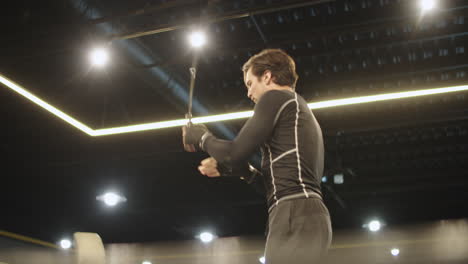 active fit man warming up before boxing at gym. male boxer jumping in sport club