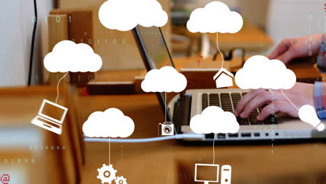 typing on laptop in office, cloud computing icons with animation overlaying screen
