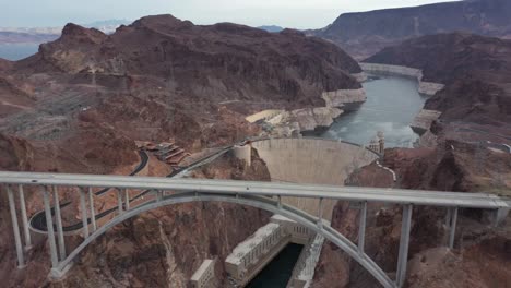 aerial view of the hoover dam with the mike o'callaghan–pat tillman memorial bridge and lake mead in sight