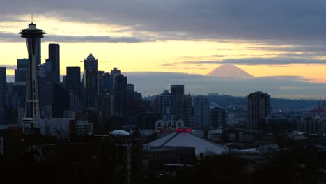 space needle seattle skyline mt. rainier on a cloudy morning just before sunrise - birds flying swooping flyby - mt. rainier in the colorful background - panning right - 4k