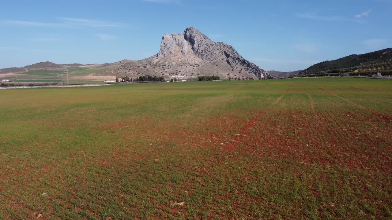 Spectacular aerial flight over the enclave of Pe&ntilde;a de los Enamorados, a rock formation in the shape of a human face in the municipality of Antequera in Andalusia, Spain