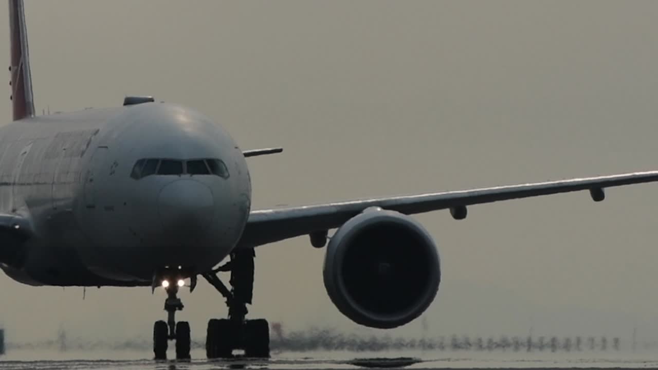 Close up of passenger jet slowly taxiing on the runway