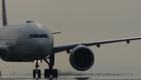 close up of passenger jet slowly taxiing on the runway
