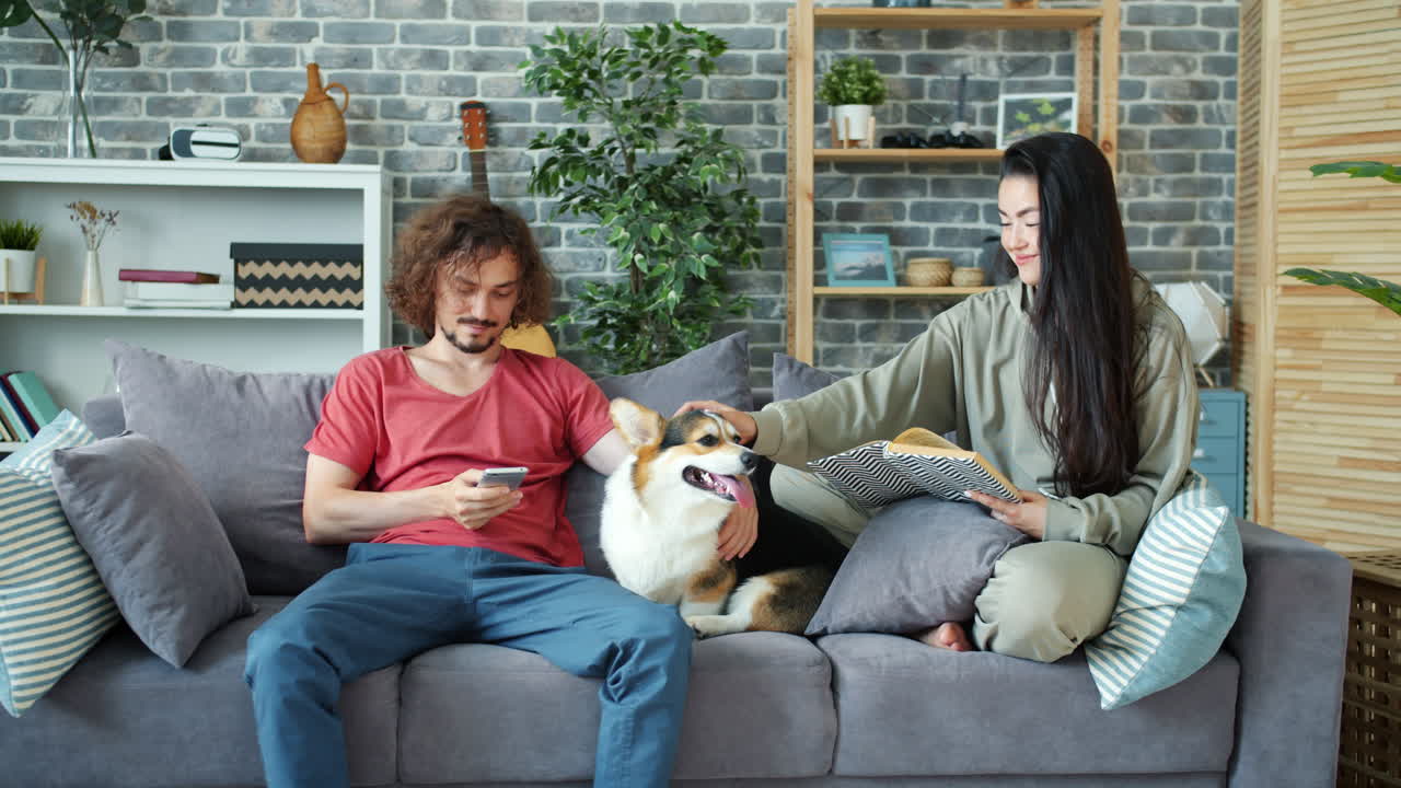 Couple Relaxing at Home with Dog