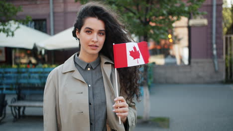 woman holding canadian flag in city