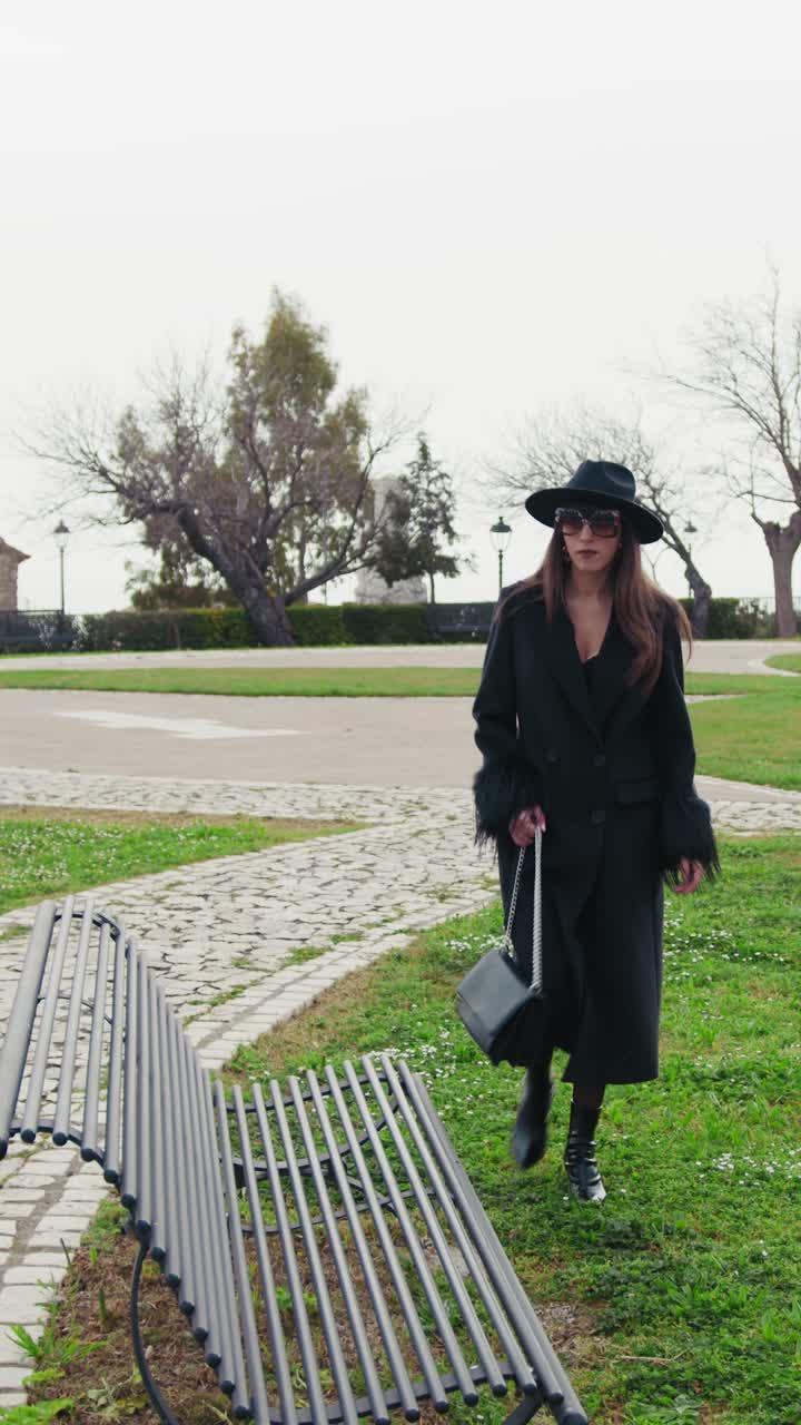 Elegant Woman Arriving At The Green Park And Sitting On The Bench