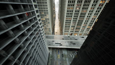 aerial hyperlapse of busy car traffic in between skyscrapers city center