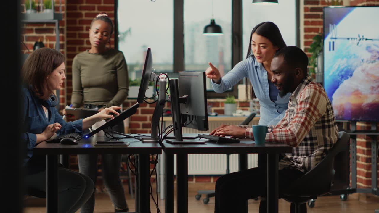 Diverse engineers working on turbine component with modern electronics