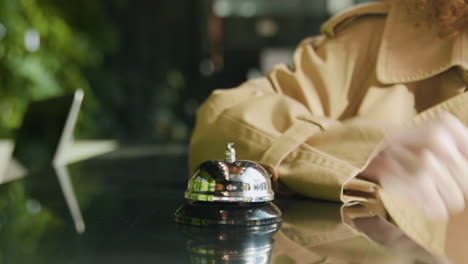 finger of a host pressing the reception bell